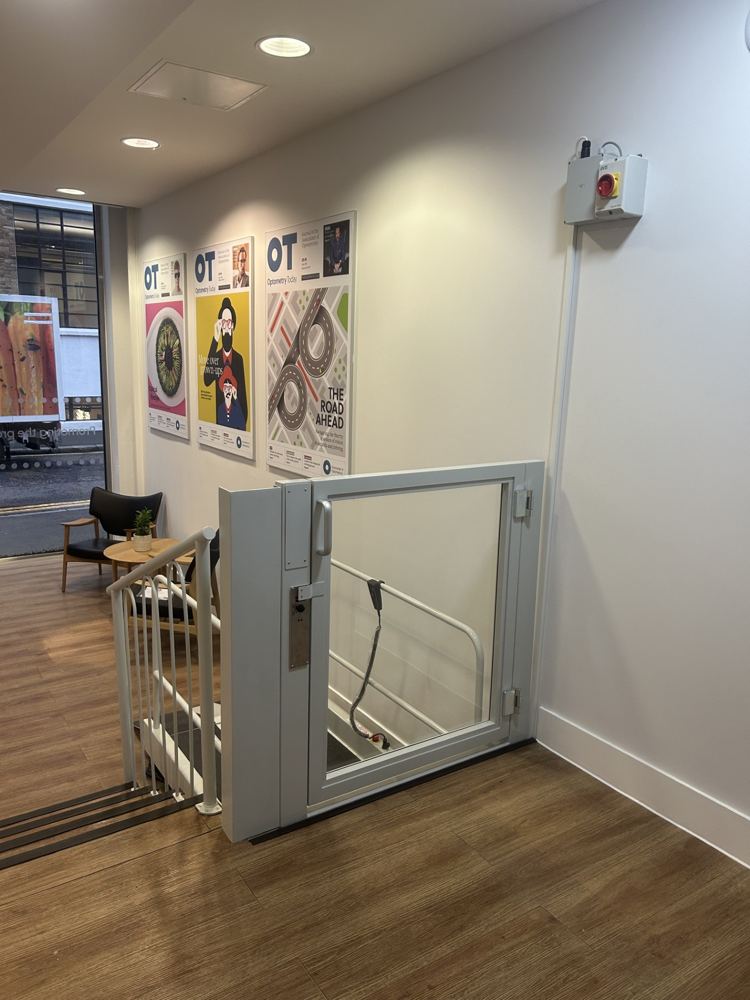 Compact step lift platform fitted to existing staircase, London office
